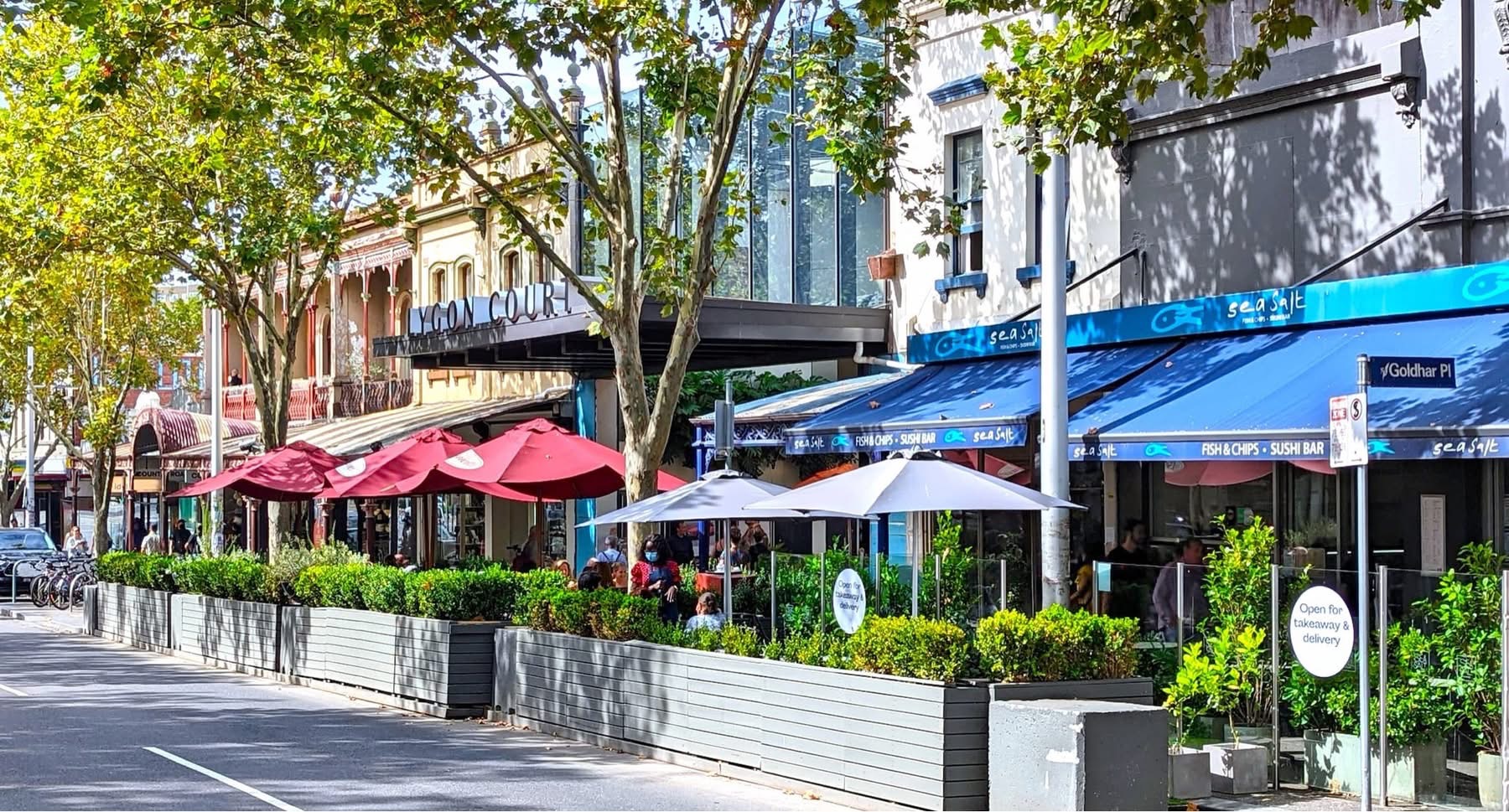 Shopping strip with historic buildings, trees and covered outdoor seating